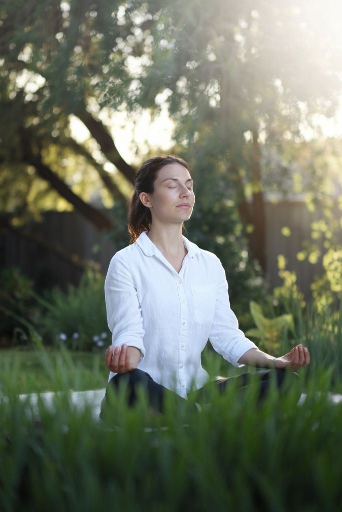 A woman in a calm, focused moment as she prunes a plant, capturing the mindfulness aspect of gardening