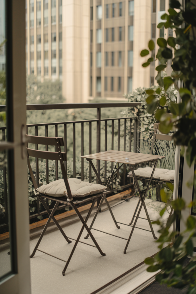 A pair of elegant folding chairs with a matching foldable table, perfect for small spaces